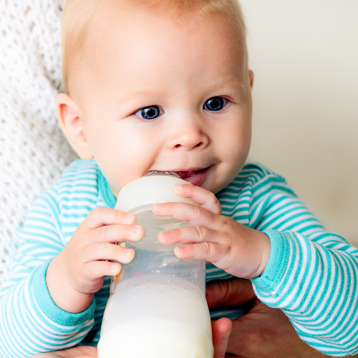 baby chewing on bottle
